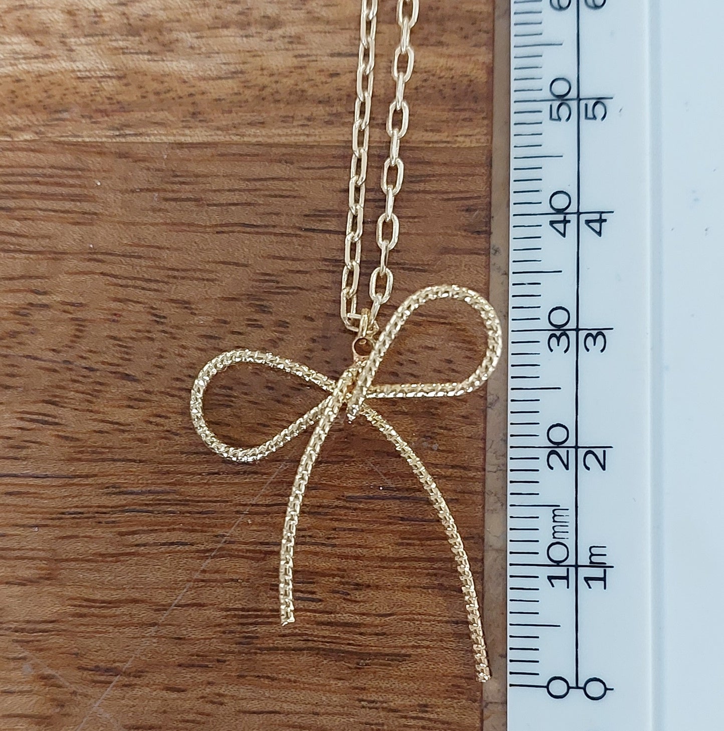 Gold bow necklace.