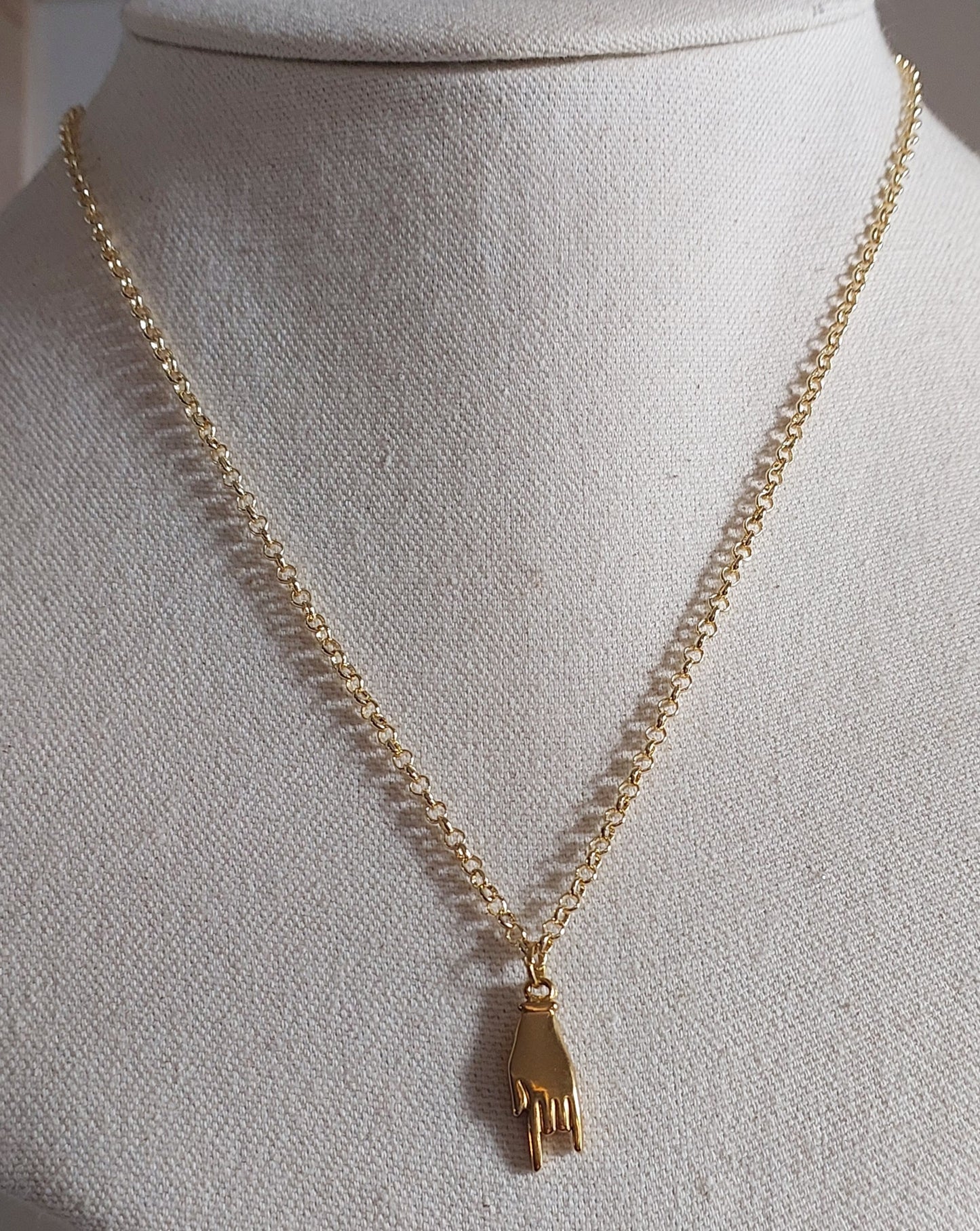 Golden hand necklace