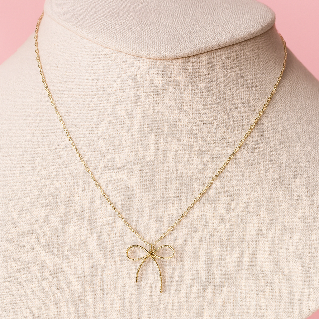 Gold bow necklace.